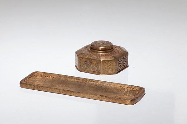 Tiffany Studios Zodiac Inkwell and Pen Tray : Tiffany Studios Zodiac Inkwell and Pen Tray A Tiffany Studios gilted bronze inkwell and pen tray in the Zodiac pattern. Marked Tiffany Studios New York 842 and 1000; ht. 2.25 in., l. 10.13 in.