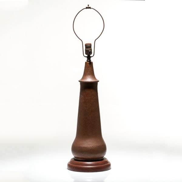 Gustav Stickley Hammered Copper Lamp Base : Gustav Stickley Hammered Copper Lamp Base American, early 20th century. A Gustav Stickley hammered copper lamp with a single socket on a wooden base. With mark on side of lamp; ht. approx 21 in.