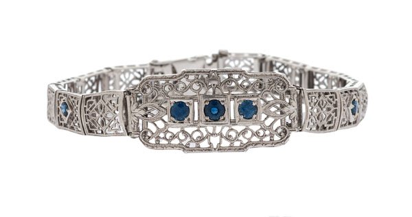 Blue Sapphire Filigree Bracelet in 14 Karat : A vintage 14k white gold filigree bracelet containing seven 3-3.5mm. round blue sapphires set in alternating links. With fold-over safety and safety chain. 9.3 dwt. 7" length