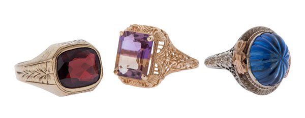 Gemstone Rings in Karat Gold : A group of 10k and 14k yellow and white gold rings. The first is a 14k white gold filigree ring ca 1915 by Belais containing one 14mm x 10mm oval carved blue center stone set in a bezel and adorned wi