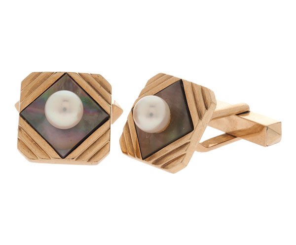 Mikimoto Signed Cuff Links in 14 Karat Yellow Gold : A pair of 14k yellow gold cufflinks featuring a geometric design with mother of pearl inlays accented with 5mm pearl center stones. Toggle backs. Signed K. Mikimoto, Tokyo. 6.5 dwt. 13.3mm square