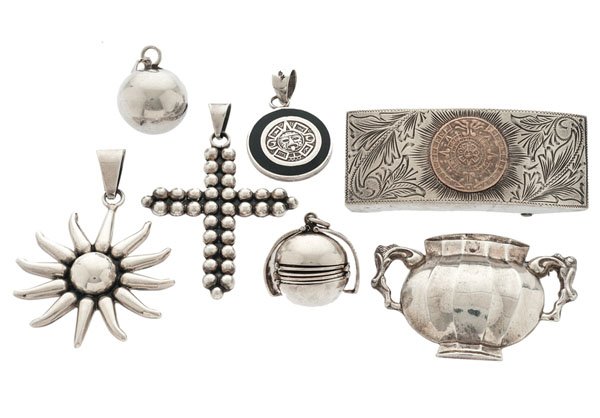 Sterling Silver Jewelry from Various Artists : A seven-piece grouping of sterling silver jewelry including a "Tussy Mussy" from Stieff Silversmiths, a Mexican-made chime ball, a folding locket, a stylized Mayan calendar belt buckle and three sterl