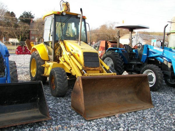 New Holland LB90 4x4 Tractor Loader Backhoe: This is a New Holland LB90 4x4 tractor loader backhoe with extenda hoe. This backhoe is powered by a 98 horsepower diesel engine with 3766 hours. This backhoe has a 80" front bucket, 22" rear toothed