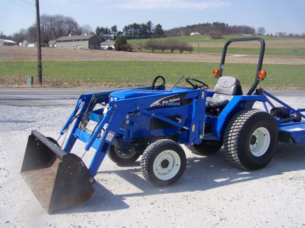 New Holland TC 30 4x4 Compact Tractor with Loader: This is a very nice 2005 New Holland TC30 4x4 compact tractor with NH 7308 loader. This tractor has 211 hours and is powered by a 30 horsepower diesel engine. This tractor has a gear transmission, 3pt