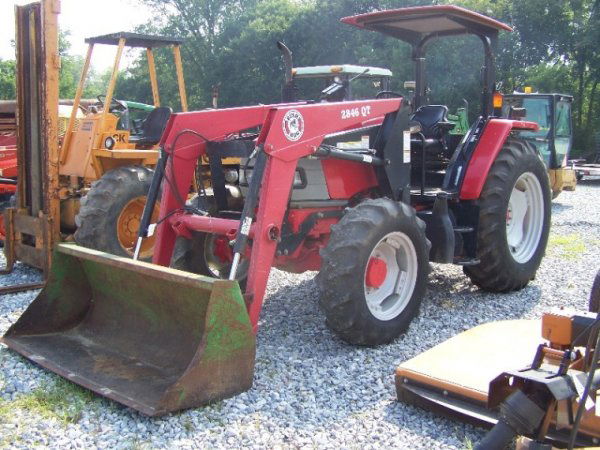 McCormick CX 75 Farm Tractor with Loader: McCormick CX75 farm tractor with Bush Hog QT 38462 loader. This tractor has 73 horsepower diesel engine, manual transmission, 1148 hours, Dual PTO, and 16.9-34 R-1 rear tires. Serial # JJE2056784 This