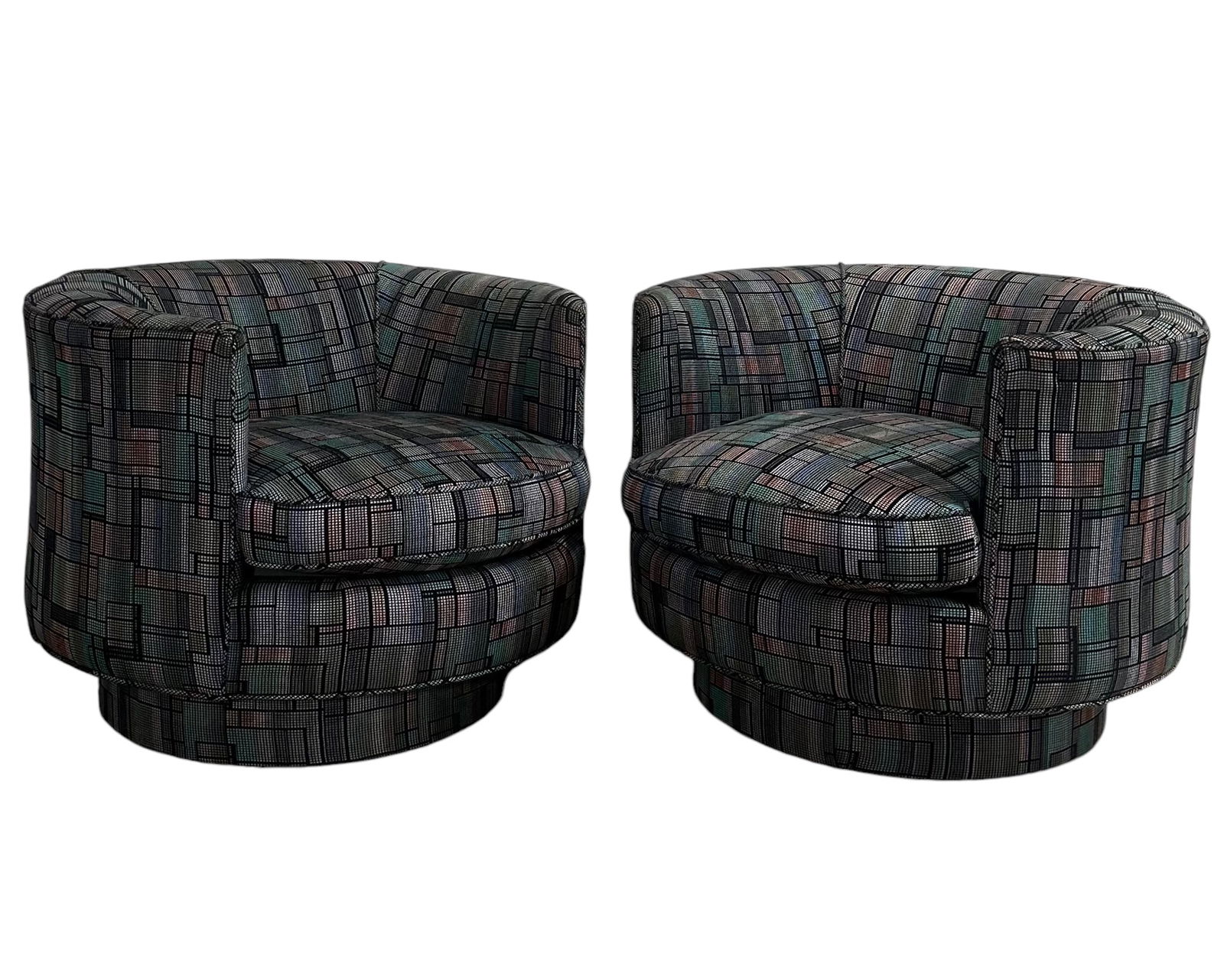 Post Modern Barrel Swivel Chairs, 1980: Elevate your living space with these exquisite Post Modern Barrel Swivel Chairs, a stunning embodiment of 1980s design. Adorned in a striking black and blue patterned fabric, these chairs offer both c