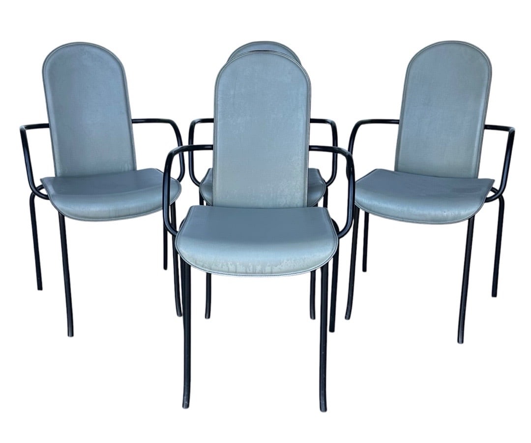 Giorgio Cattelan for Cidue, Gray Leather and Steel Dining Chairs, Italy: Indulge in the exquisite craftsmanship of the Giorgio Cattelan for Cidue dining chairs, a stunning fusion of modern design and luxurious comfort. Each chair features a robust black metal frame that ex