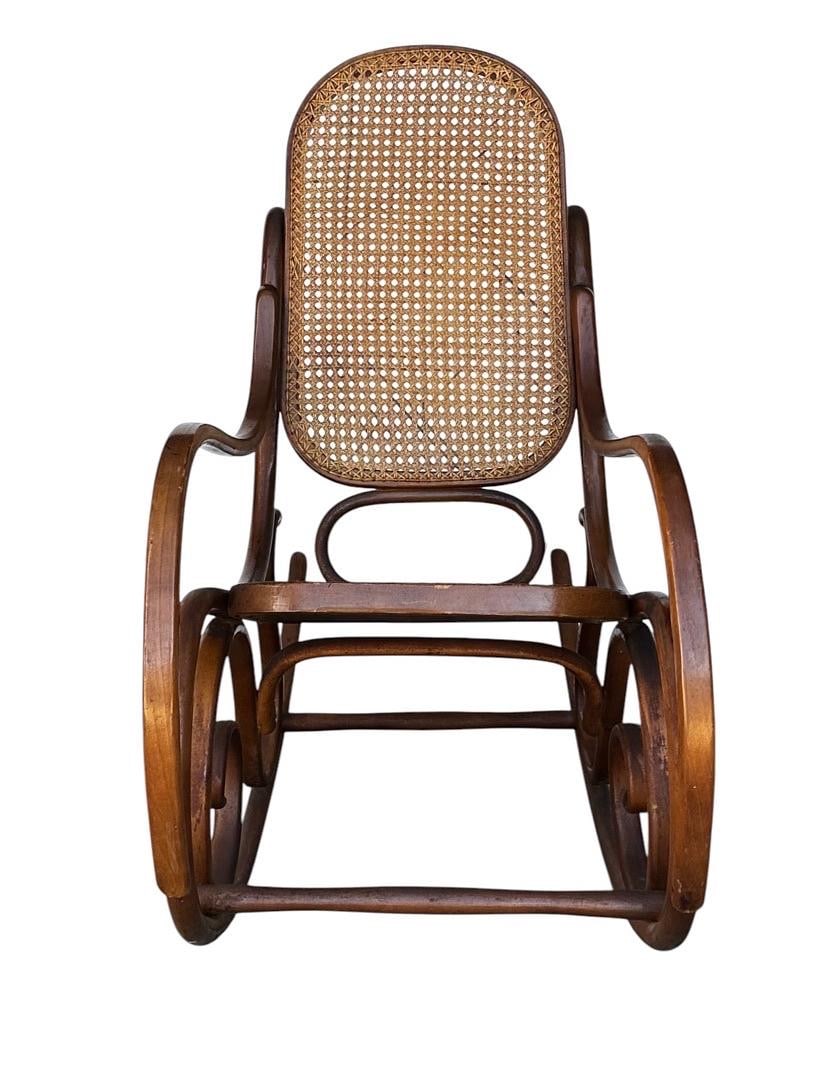 Michael Thonet for Thonet Wicker and Walnut Rocking Chair, 1960s: Michael Thonet for Thonet Wicker and Walnut Rocking Chair, 1960s.Measures 40.5” tall 19.25” wide 18.5” deep seat height 20” depth 16”PLEASE BE ADVISED, THE JOLIET WAREHOU