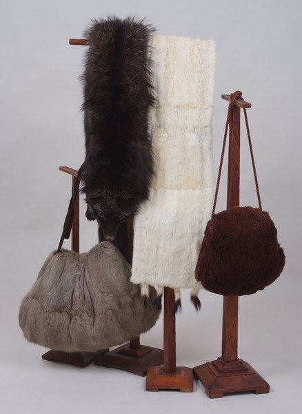 A COLLECTION OF 1930'S FUR STOLES & MUFFS. To include: A COLLECTION OF 1930'S FUR STOLES & MUFFS. To include a silver fox stole with head and tails, a long cream ermine stole, lined with ermine tails and labelled 'Dickins & Jones'. A grey muff and a furth