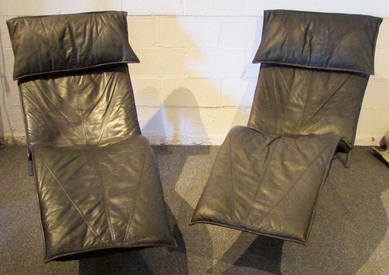 Pair Leather Tord Bjorklund Recliners: Each with black leather cushion with molded "pillow" fitted over a fabric suspension base. The chromed tubular frame with cross stretcher. Attributed to Tord Bjorklund, Denmark. Height 38 inches, widt