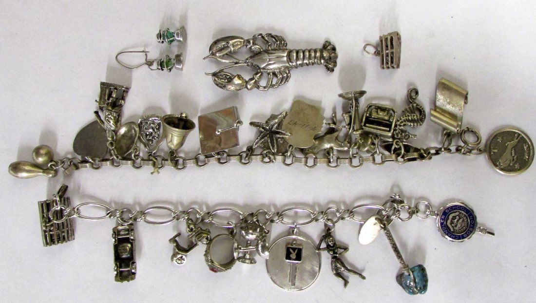 Group of Sterling Bracelets and Charms: The lot comprised of two sterling charm bracelets with charms, together with a sterling lobster pin, lobster cage charm, and loose two lantern charms.