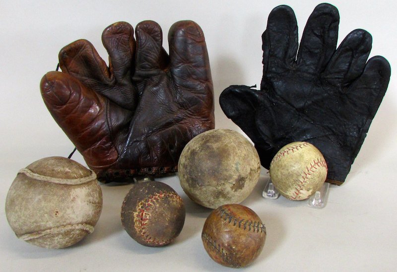 Group of 5 Early Baseballs and 2 Gloves.: The lot comprised of 2 hand stitched softballs, 3 early stitched baseballs, and 2 gloves, the first an unpadded leather mitt, the second a Reach 1940's fielders glove.