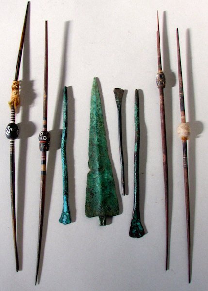 Group of Small Weapons: The lot comprised of wood and beaded blow darts, three bronze darts, and a bronze spear tip. Length of darts 10 1/2 inches.