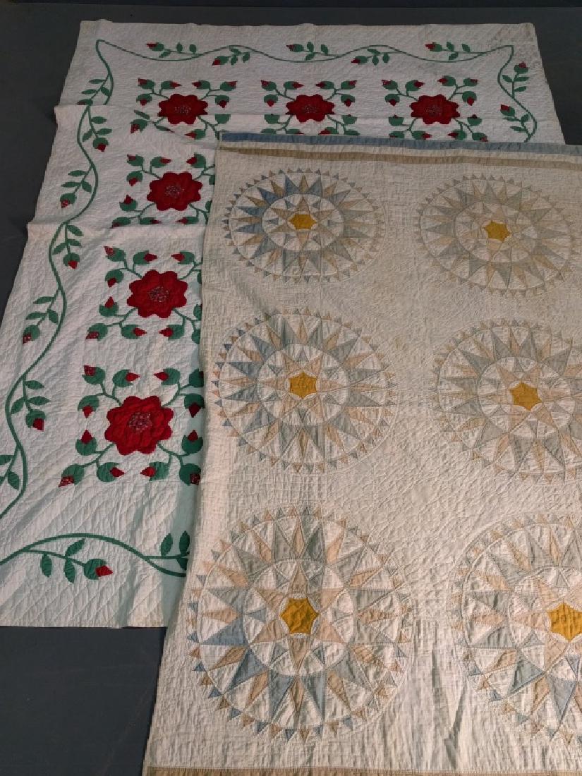 Applique quilt: Applique quilt with red flowers and vine border, 85" x 64", together with a compass quilt. As found.