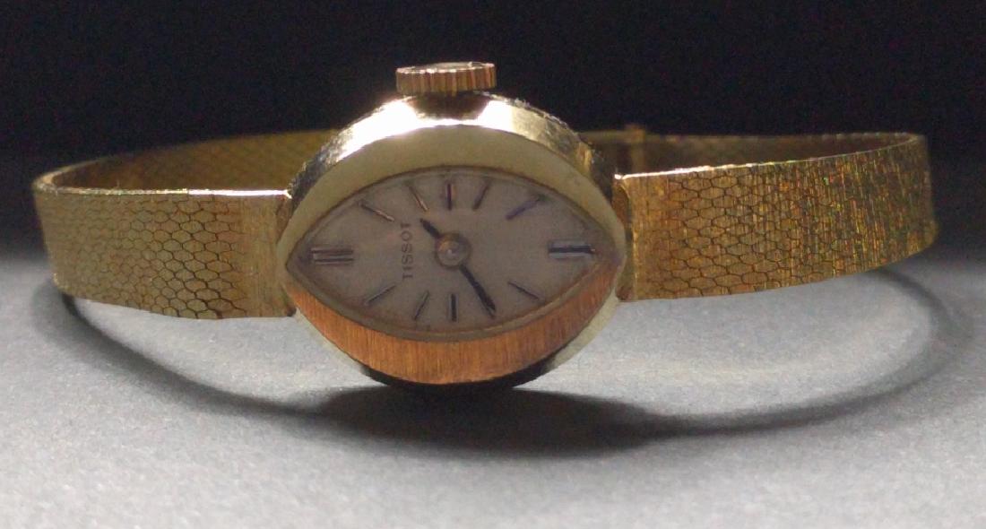 14 Karat Gold Ladies Watch: Tissot 14 karat gold ladies watch with 14 karat mesh bracelet, seventeen jewel Swiss made movement #13243263, case number TF2596, with the back engraved. Watch appears to be in running condition. 5.25