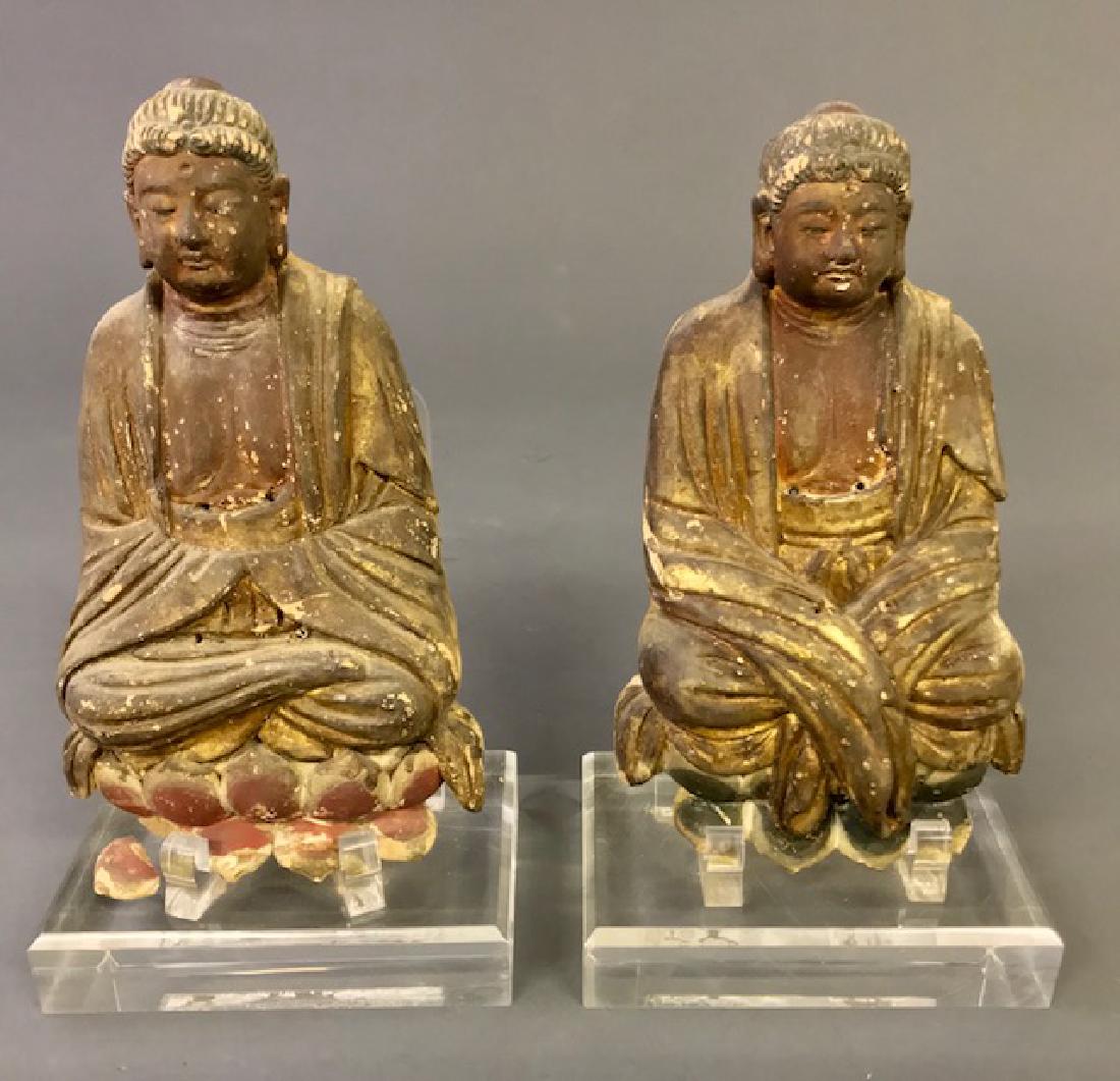 Two Chinese Ceramic Carved Seated Buddhas: Two Chinese ceramic carved seated Buddhas, Ming Dynasty style, with traces of old paint decoration, each 10"h