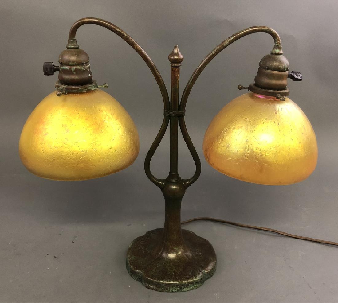 Tiffany Style Lamp with Favrile Glass Shades: Tiffany style twin light table lamp by Lundberg Studios (Davenport, California) with twin yellow favrile glass shades above bronze lyre form base, 20th / 21st c, 16"h x 17"w, 7" shade dia
