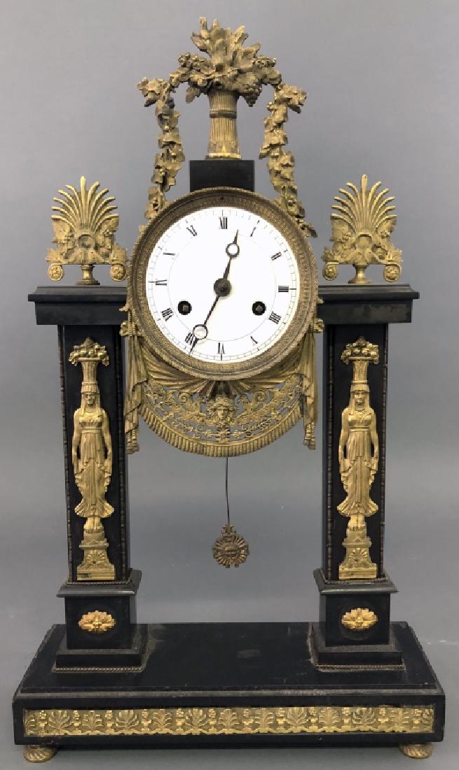 Egyptian Revival French Onyx Clock: Egyptian Revival French onyx clock, 19th c, with gilt ormolu mounts, 21 1/2"h x 13"w. W.A.I. does not guarantee clocks to be complete or in working condition.