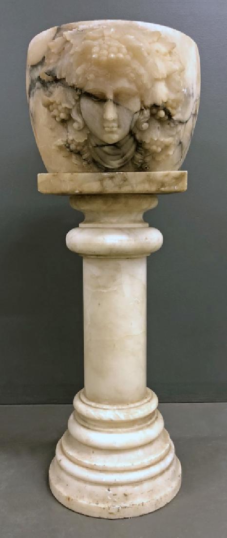 Alabaster Carved Planter on a Pedestal: Alabaster planter, 10"h, carved with face and grapes, on a pedestal, 27"h, 37"h overall