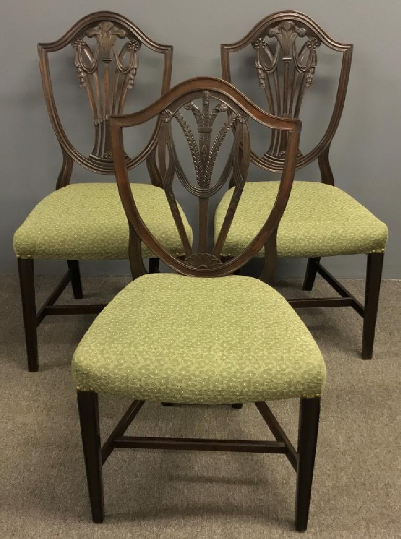 Pair of Hepplewhite Style Mahogany Chairs: Pair of Hepplewhite style mahogany side chairs with carved Prince of Wales feather together with another chair, each approximately 39"h x 20"w x 16 1/2"d, seat height = 18"
