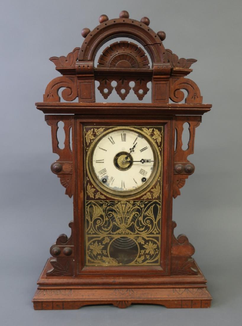 Victorian Walnut Mantel Clock By Seth Thomas: Large Victorian walnut mantel clock by Seth Thomas, with alarm, 24"h x 15 1/2"w W.A.I. does not guarantee clocks to be complete or in working order.