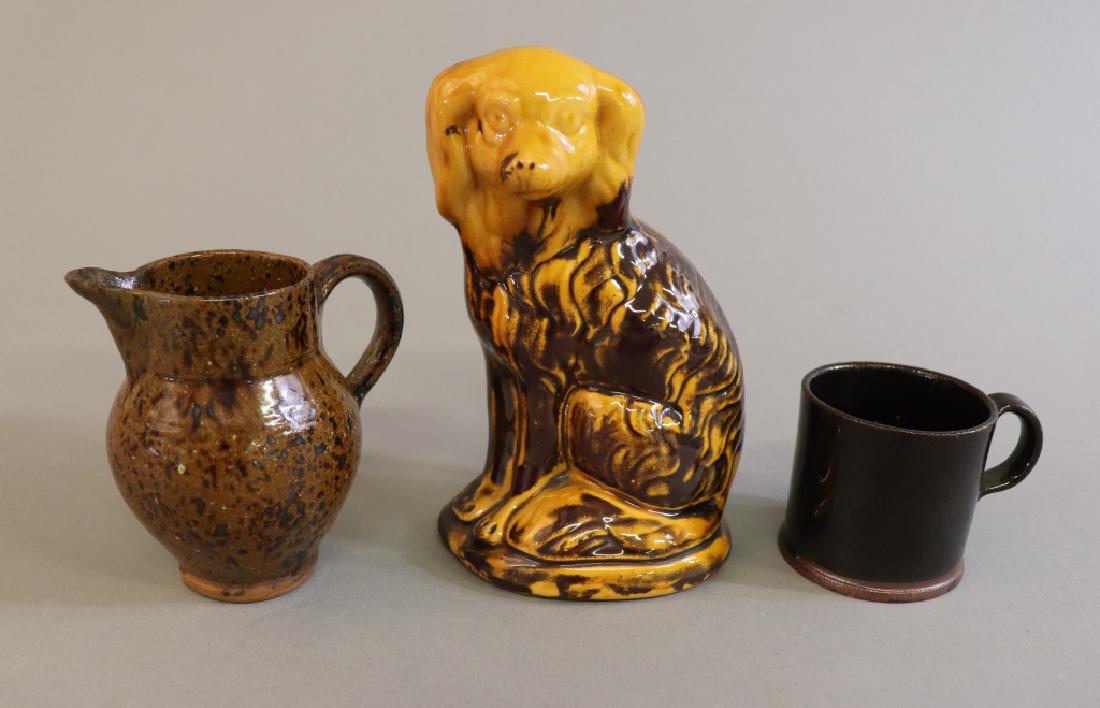 Small Redware Dog with Pitcher and Cup: Small redware seated dog, 5 1/2"h, together with a small pitcher and cup