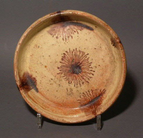 Redware saucer with yellow and manganese decorat