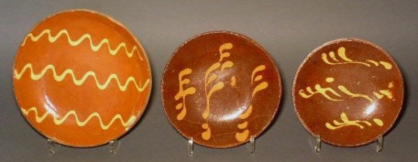 Three redware dishes with slip decoration. 9"dia