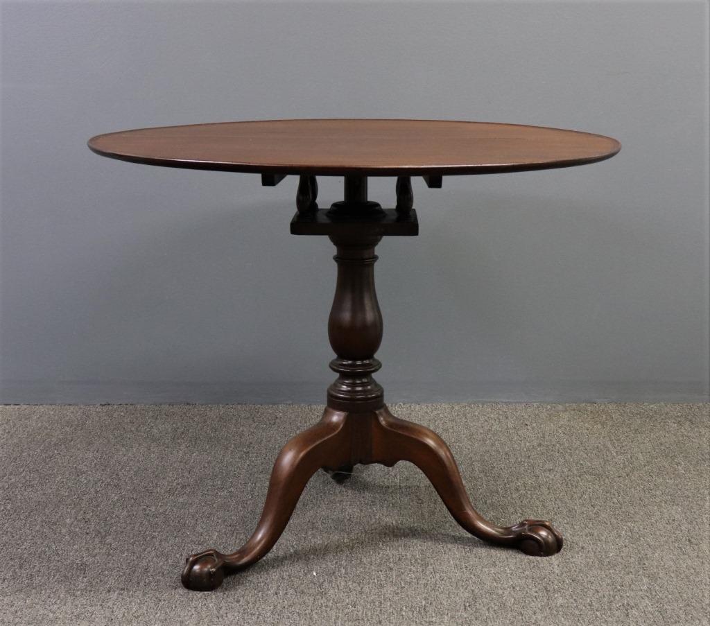 Chippendale Mahogany Dish Top Tea Table: Chippendale mahogany dish top tea table, with birdcage support and finely carved ball and claw feet, 29"h x 34 1/2"dia