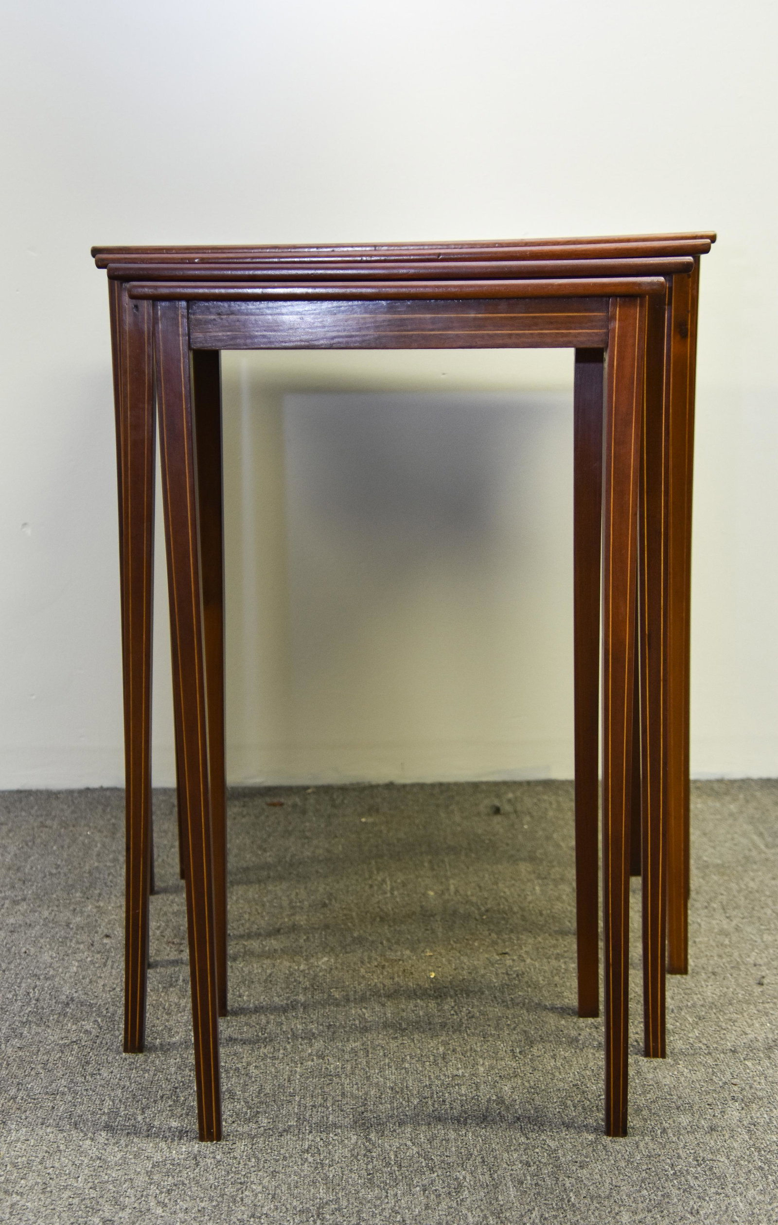 Nest of Tables: Nest of four Hepplewhite style mahogany inlaid tables Largest 30"h x 27"w. 19"d