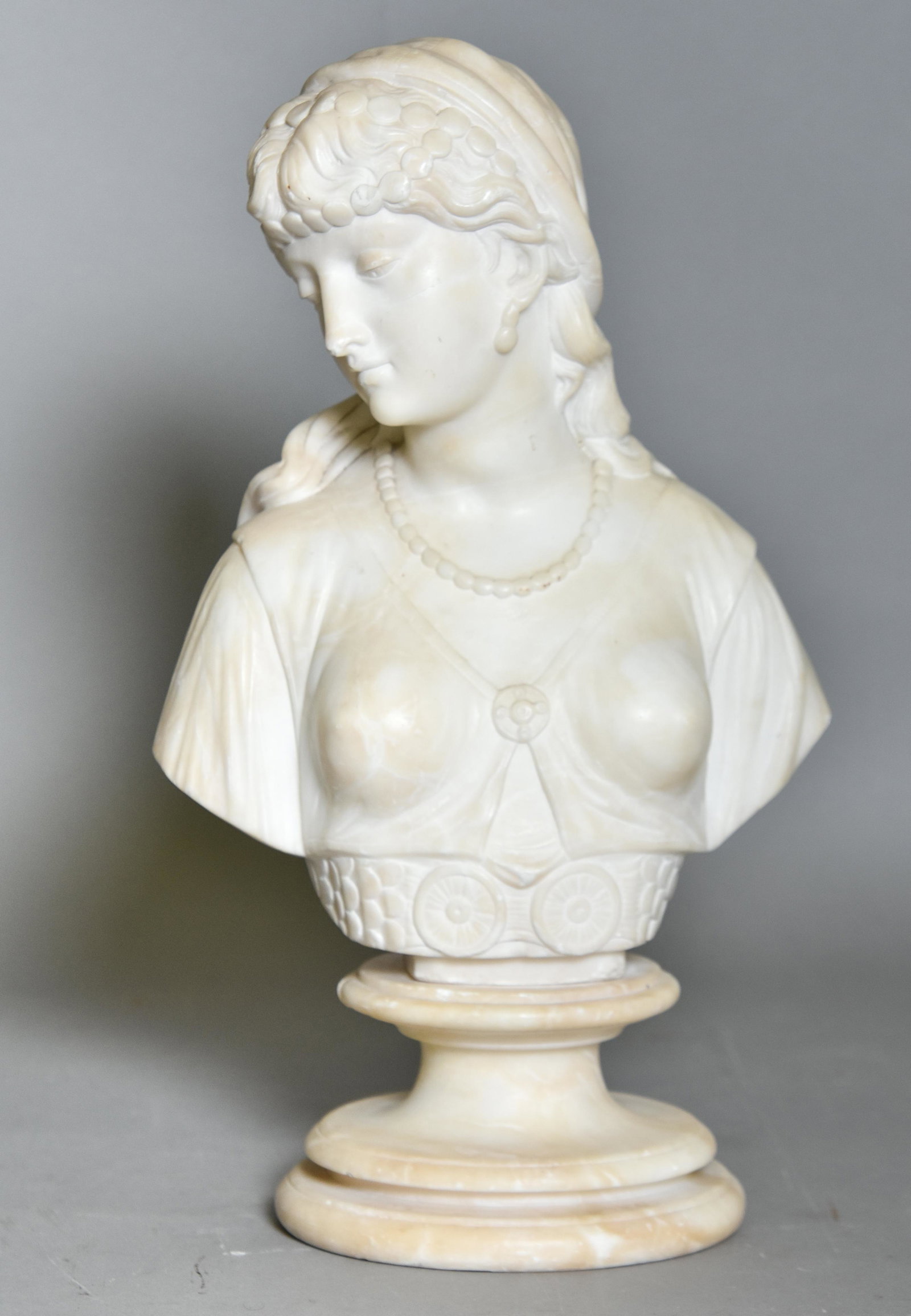 Alabaster Sculpture of a Woman: Alabaster sculpture of a woman mounted on a wood base 17"h x 10"w x 7"d