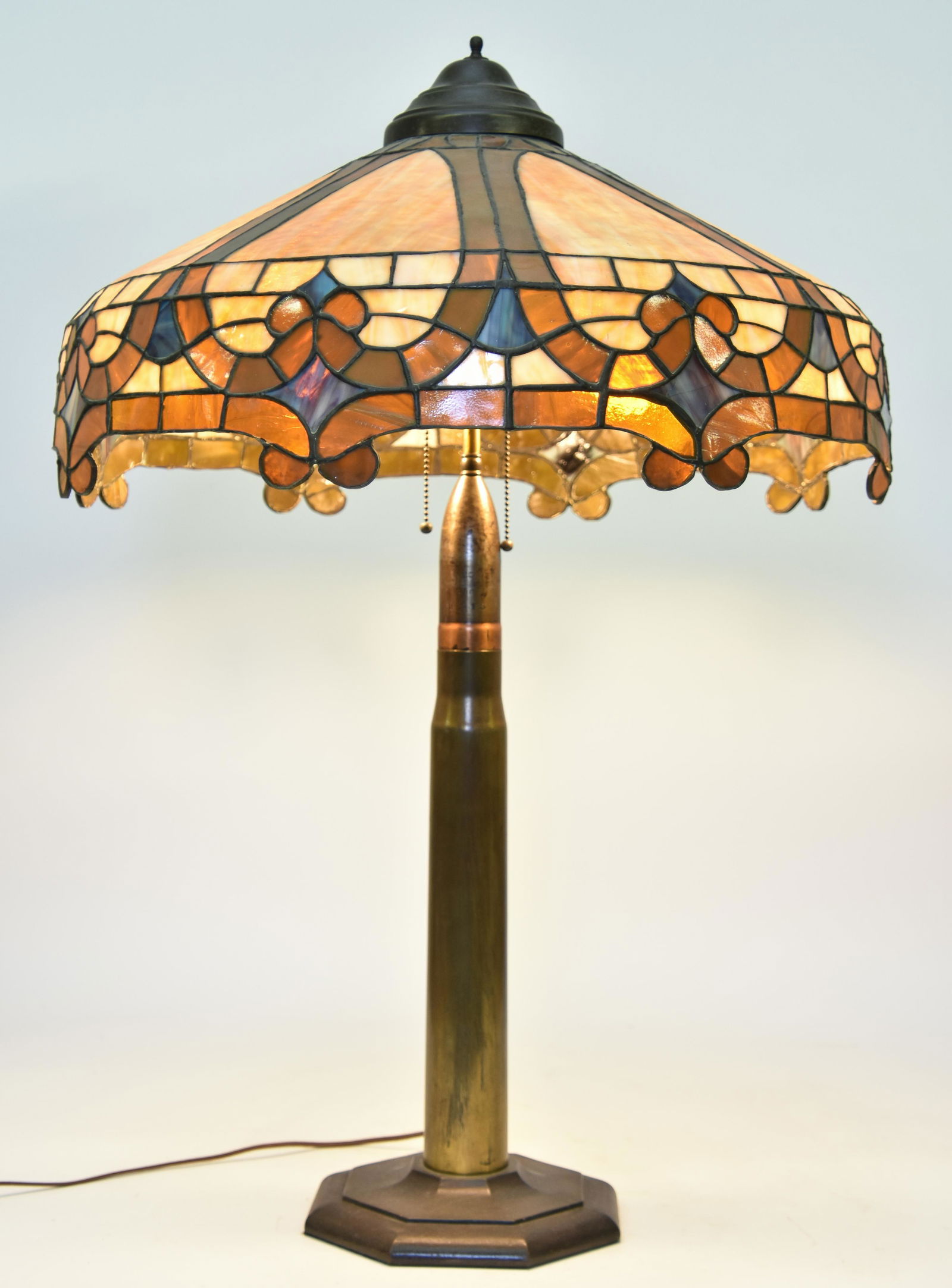 Large Leaded Glass Table Lamp: Large leaded glass table lamp with brass trench art shell base, circa 1920 34.5"h x 24"w