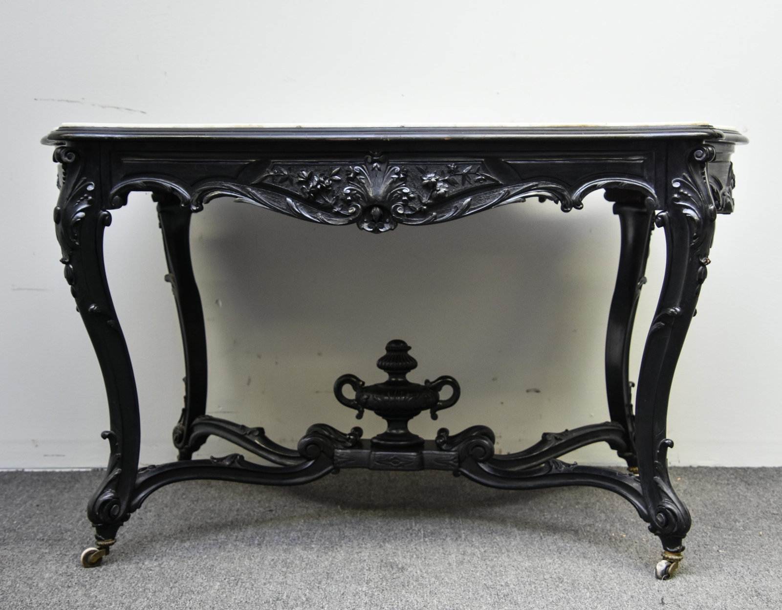 Victorian Center Hall Table: Finely carved Victorian ebonized center wall table with white marble top with drawer 30"h x 51.5"w x 34.5"d
