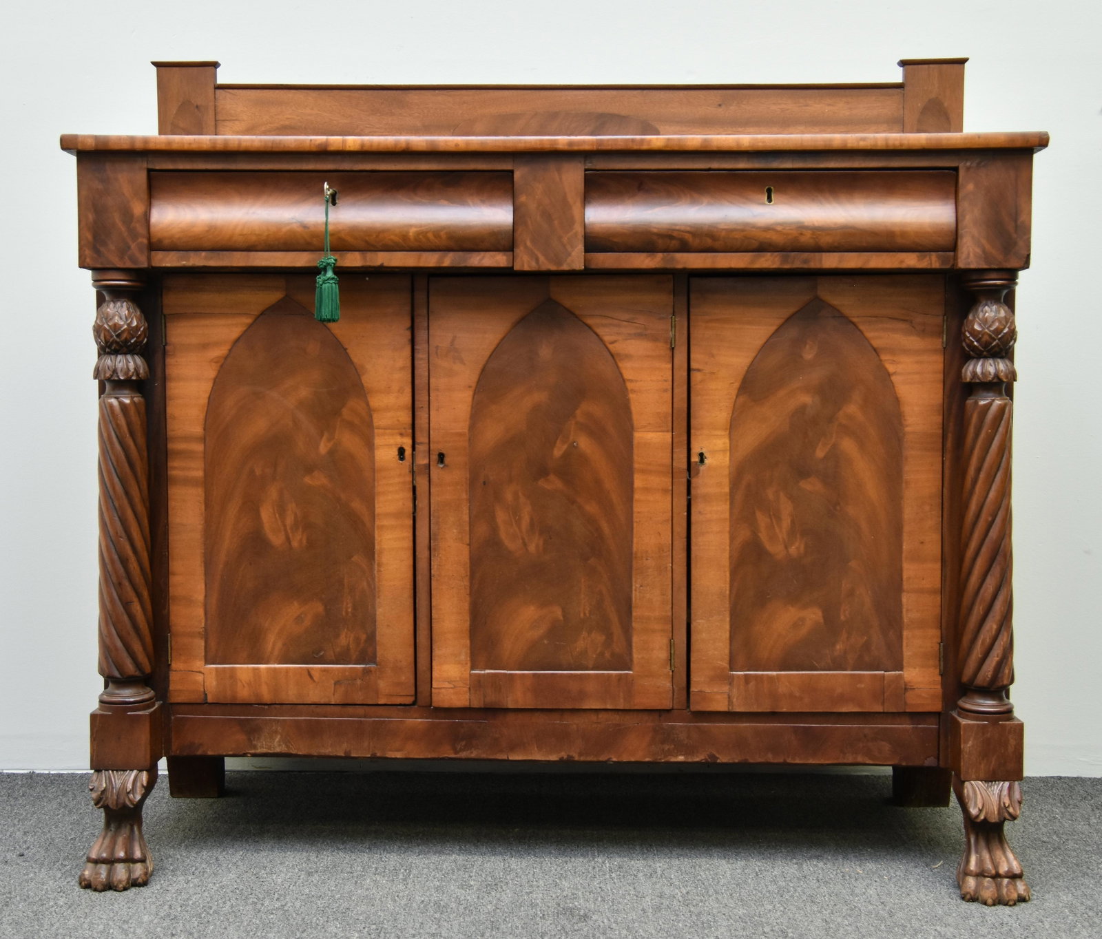 Empire Mahogany Sideboard: Empire mahogany sideboard, circa 1870 with inlaid backsplash and carved columns, paw feet 50"h x 54"w x 20.25"d