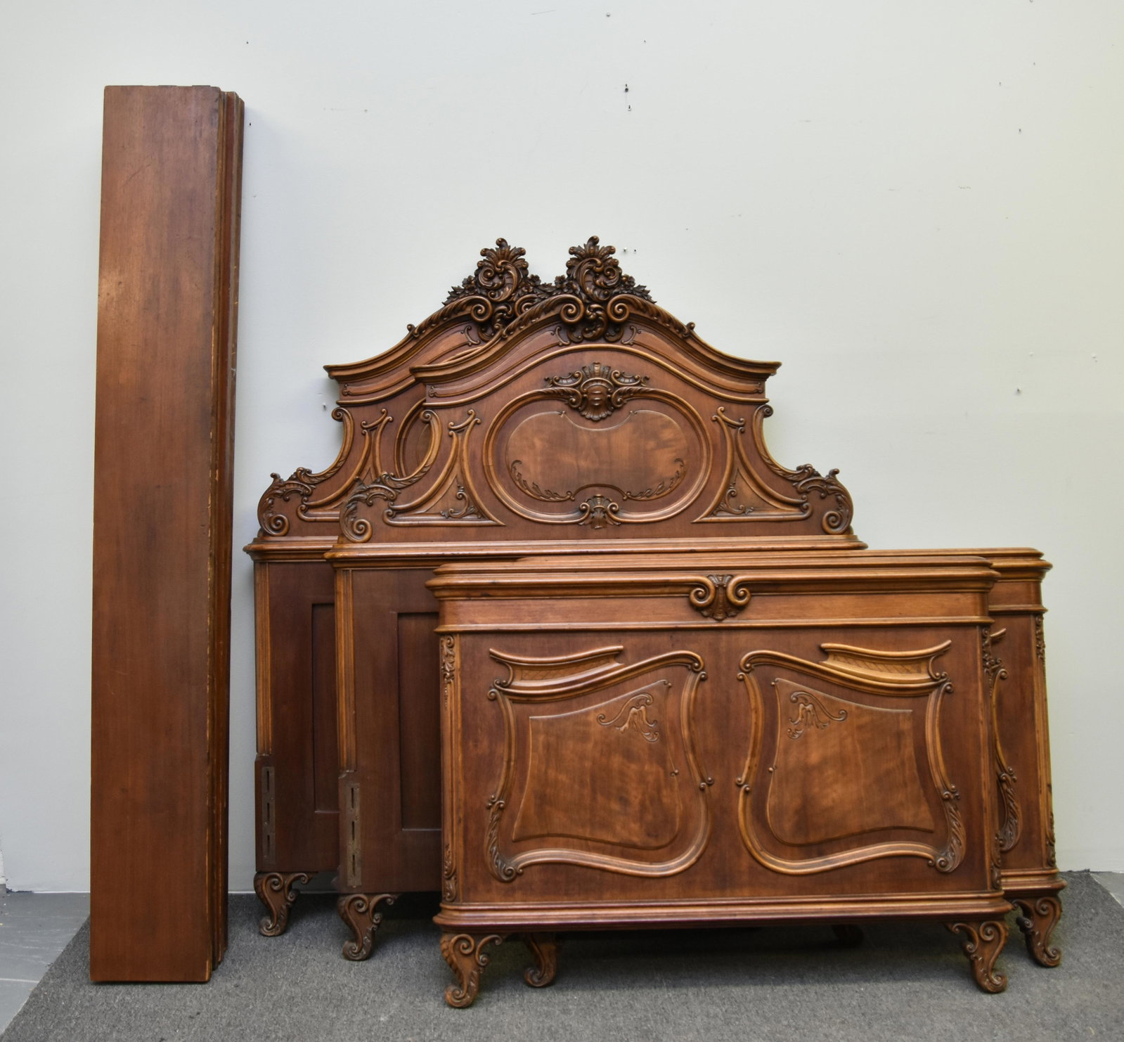 Pair of French Walnut Twin Beds: Pair of French walnut twin beds with finely carved headboards, late 19th c. Headboards: 62"h x 47"w Footboards: 36"h x 48"w Rails: 74.5"l