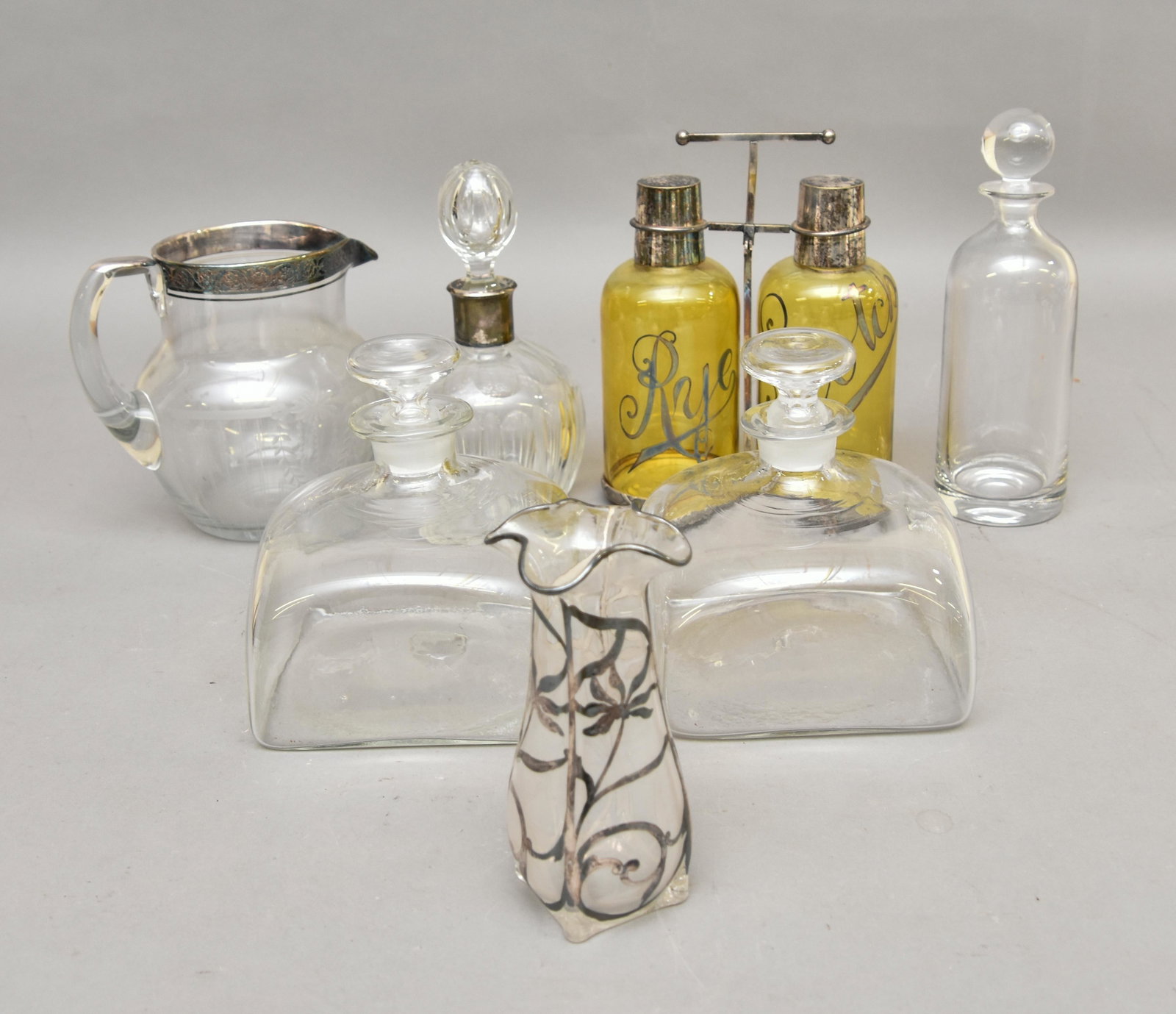 Silver Overlay Bar Set etc.: Amber glass silver overlay bar set, a pitcher, decanter and two blown ships' decanters etc. Tallest 10"h