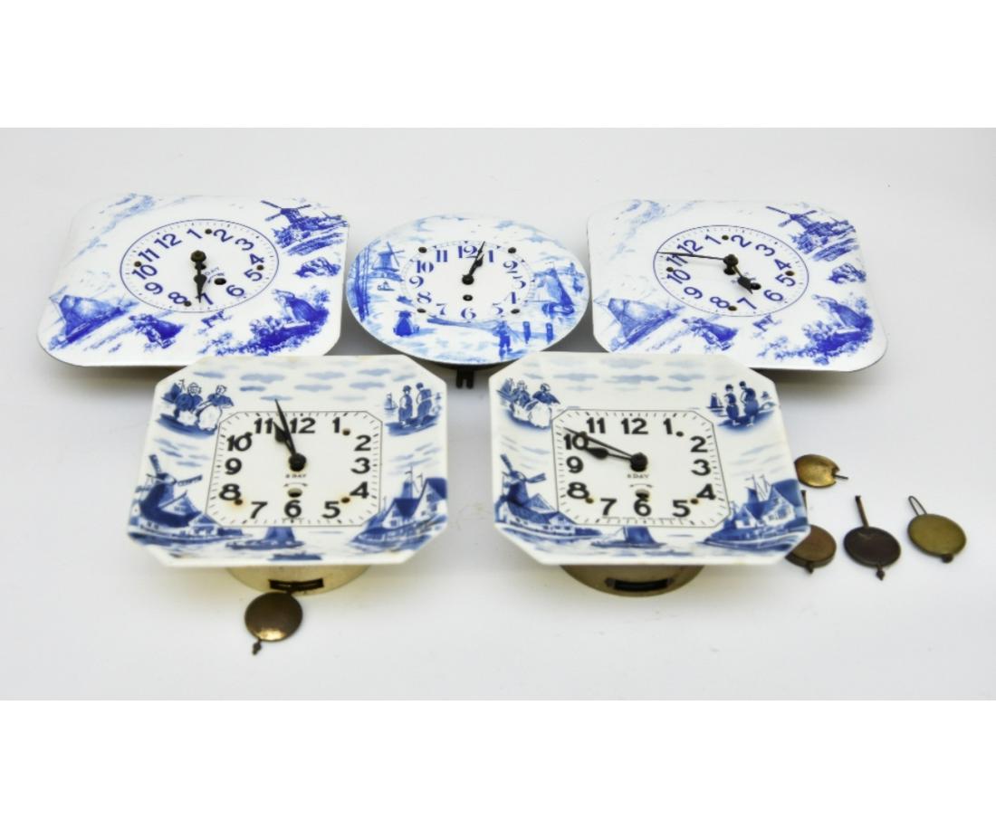 Enameled Wall Clocks: Four German porcelain/enamel wall clocks, largest 12" x 12"; together with a Newark clock
