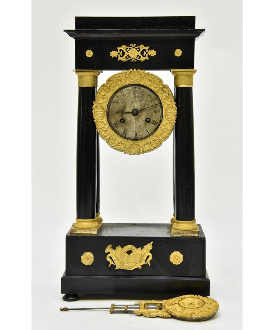 French Portico Clock: French portico clock, black lacquered wood with fire gilt ormolu mounts, 19th c. 18.5"h x 9.5"w x 5.5"d