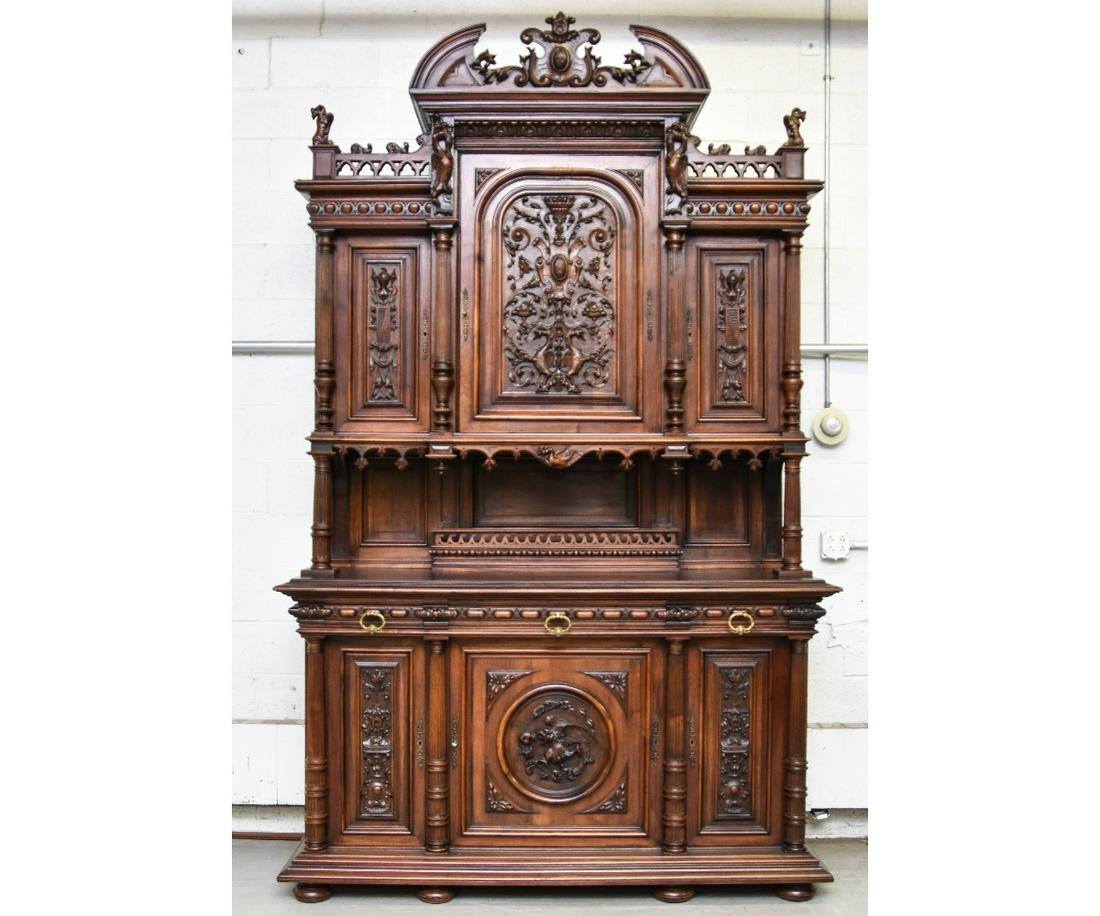 Monumental Black Forest Sideboard: Monumental Black Forest walnut sideboard with extensive carvings, circa 1890 with brass pulls and escutcheons 115.5"h x 72"w x 24.5"d