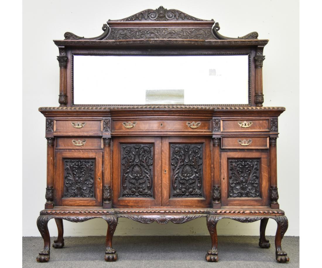 Carved Oak Sideboard: Horner Brothers (attributed) oak sideboard, circa 1900 with finely carved dolphins, ornate drawer fronts, and animal paw feet 75"h x 66"w x 23.5"d