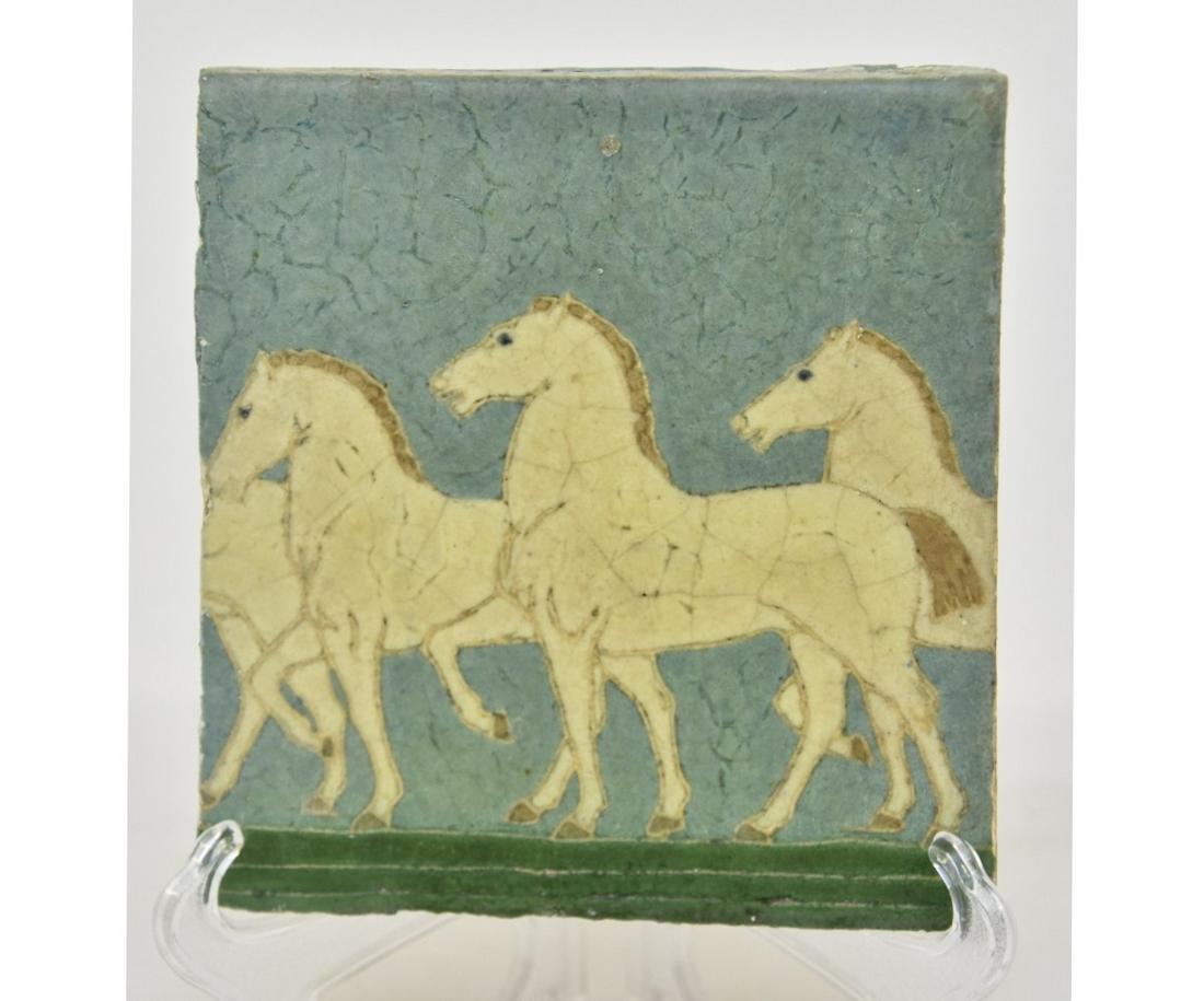 Rare Grueby Tile: Rare Grueby tile designed by Addison LeBoutillier and decorated in Cuenca with frieze of horses against a blue sky, signed 'HJZ' 1" x 6" x 6"