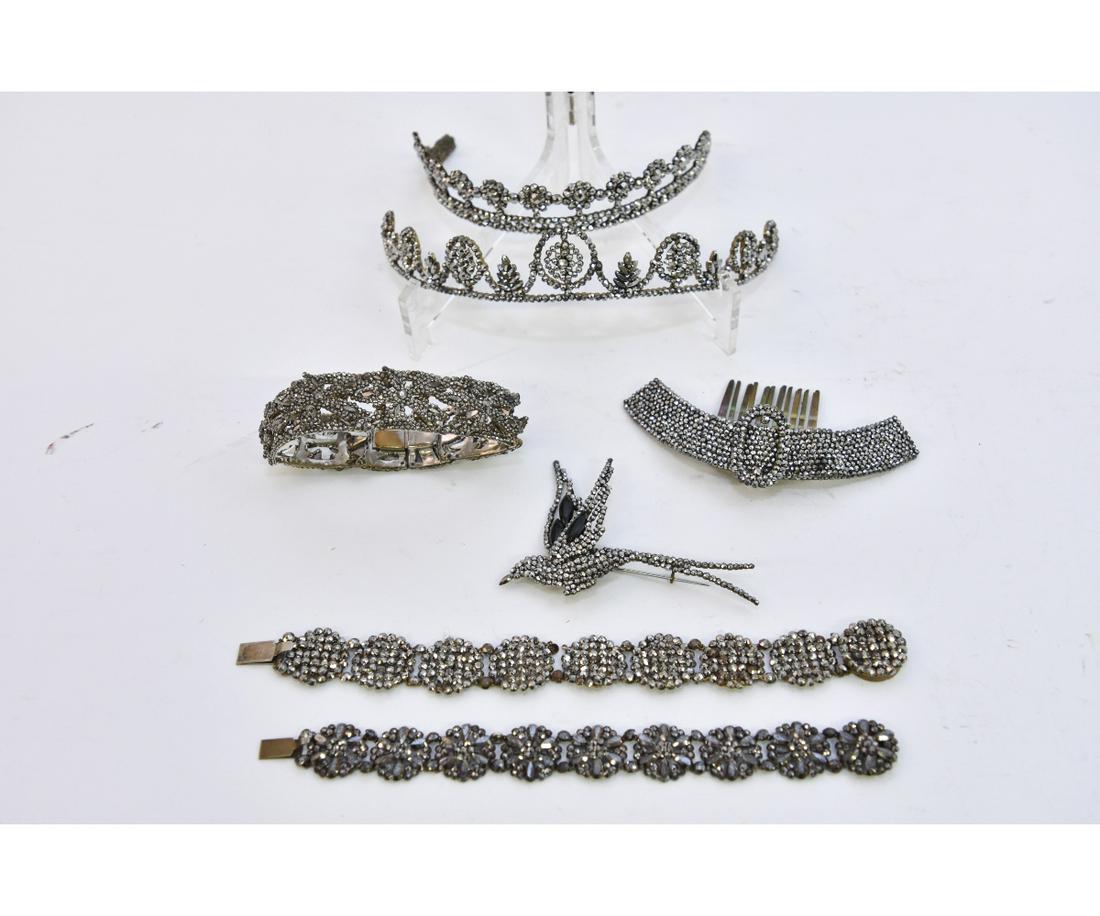 Victorian Cut Steel Jewelry: An array of 19th c. cut steel jewelry to include three bracelets, one with intricately sculpted flowers 2.5"dia x .75"w; two tiaras, largest is 6"w x 1"h; a swallow bird pin 3.5"w x 2.5"h; and a comb 