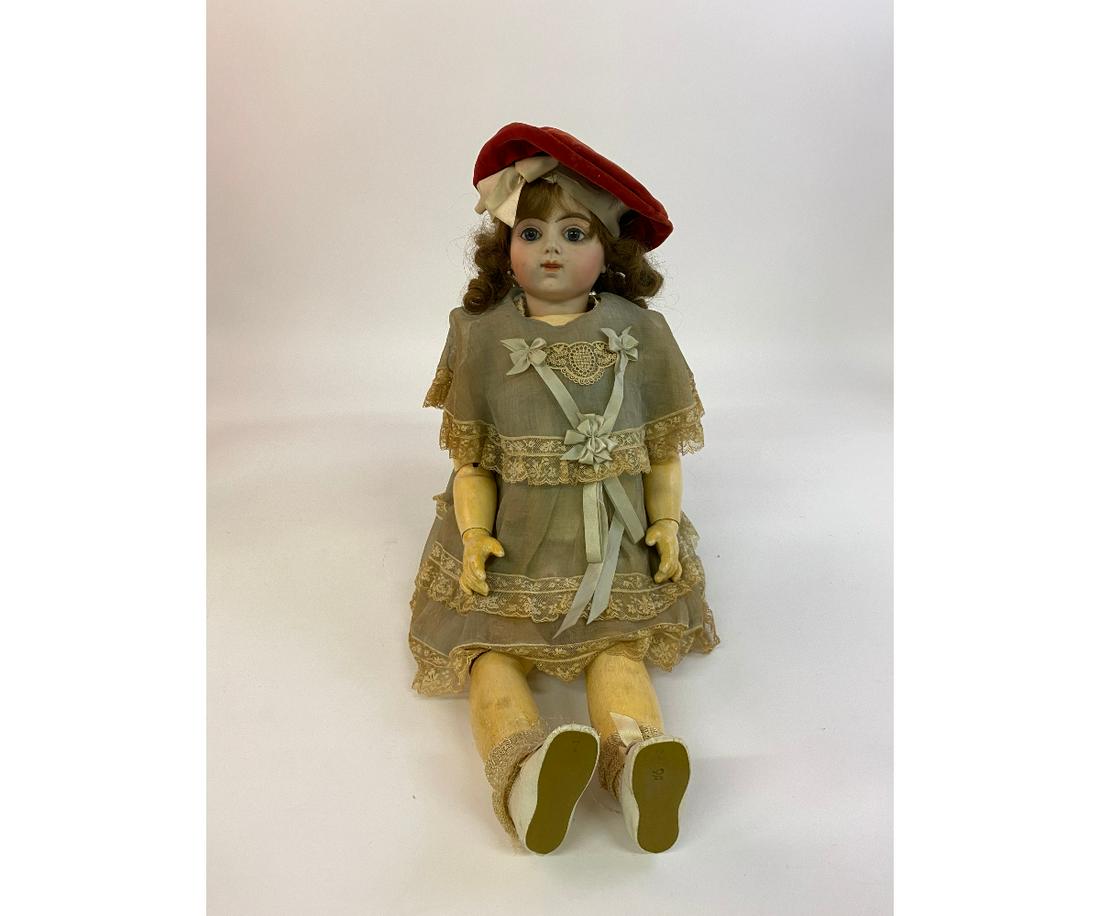 Rare Bebe Bru 10 French Doll: Rare Bebe Bru 10 French doll, 19th c., bisque head, composition body, closed mouth, pierced ears, red velvet tam (6"dia), with what appears to be the original dress with label 24"h x 8"w x 4"d