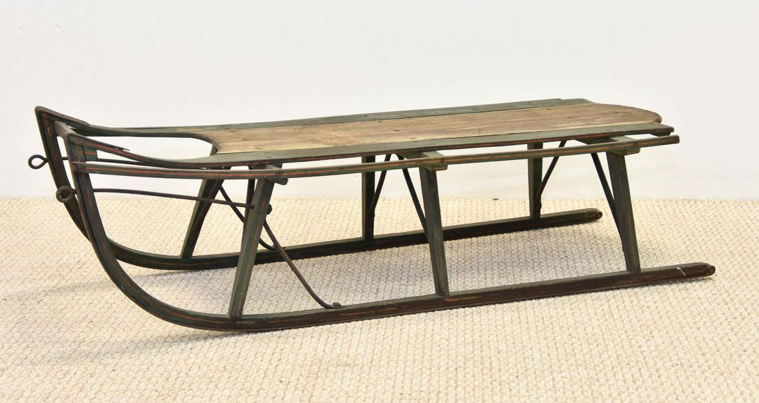 Childs Wooden Sled: Childs wooden sled with original green, white and red pin striping, 19th c., with wrought iron runners, signed 'T.M. Terry' 13.5"h x 44"l x 17"w