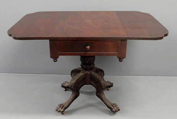 New York Classical mahogany drop-leaf table,c.1840: New York Classical mahogany drop-leaf table, c.1840, with two faux drawers, acanthus carved shaft, carved animal legs and animal paw feet ending in brass casters. 29.25”h.x20”w.x44”d., each leaf