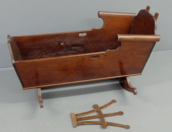 Pennsylvania walnut cradle, c.1800, with cheese cu: Pennsylvania walnut cradle, c.1800, with cheese cutter rockers. 24"h.x41"l.x28.5"w.