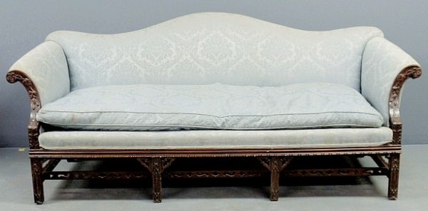 Chippendale style mahogany camelback sofa with flo: Chippendale style mahogany camelback sofa with floral carved arm supports. 35"h.x81"W.x31.5"d., seat 18"h.