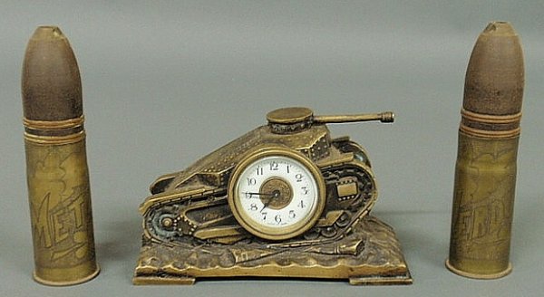 Brass tank-form clock, works marked "Made in Japan: Brass tank-form clock, works marked "Made in Japan", 4.5"h.x7"w., and two WWI trench art shells marked "Verdun" and "Metz", 6.5"h. each