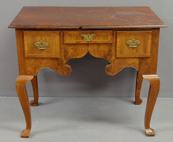 Georgian walnut lowboy with a molded top and cabri: Georgian walnut lowboy with a molded top and cabriole legs. 27.75"h.x32.5"w.x19.5"d.
