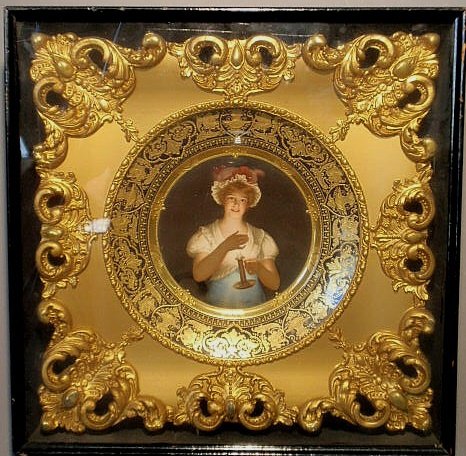 Framed Dresden plate signed "Wagner" of a woman ho: Framed Dresden plate signed "Wagner" of a woman holding a chamberstick titled verso "Lisette Dépose", plate 10" dia.